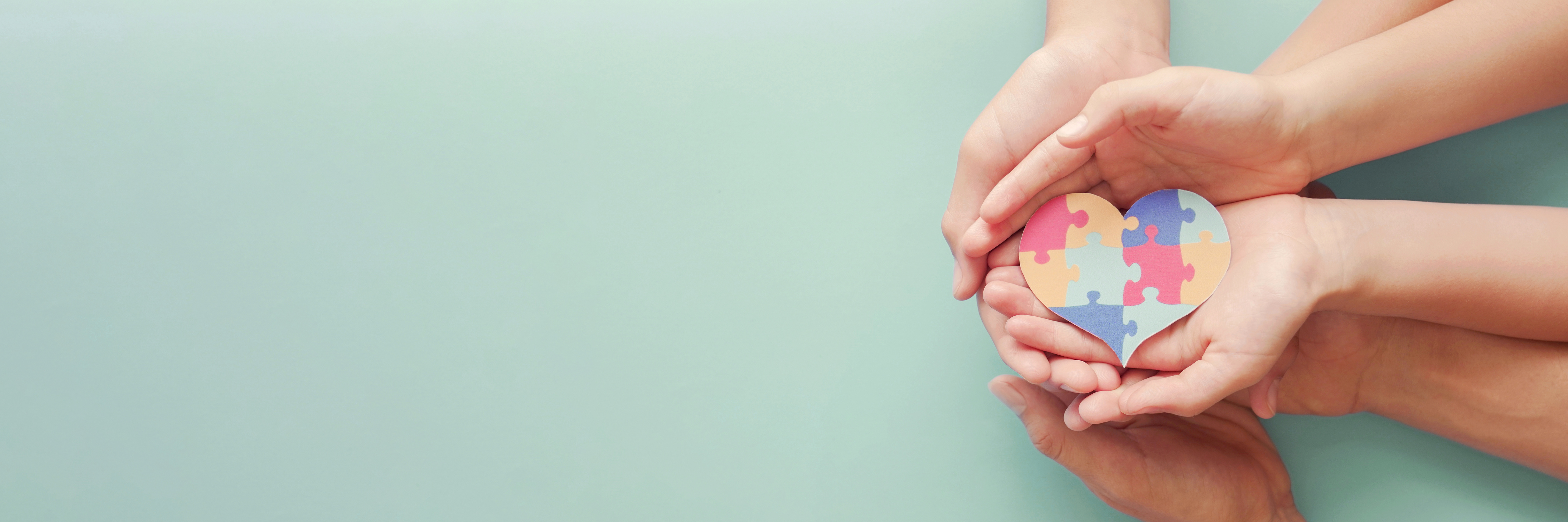 Hands Holding Puzzle Heart 